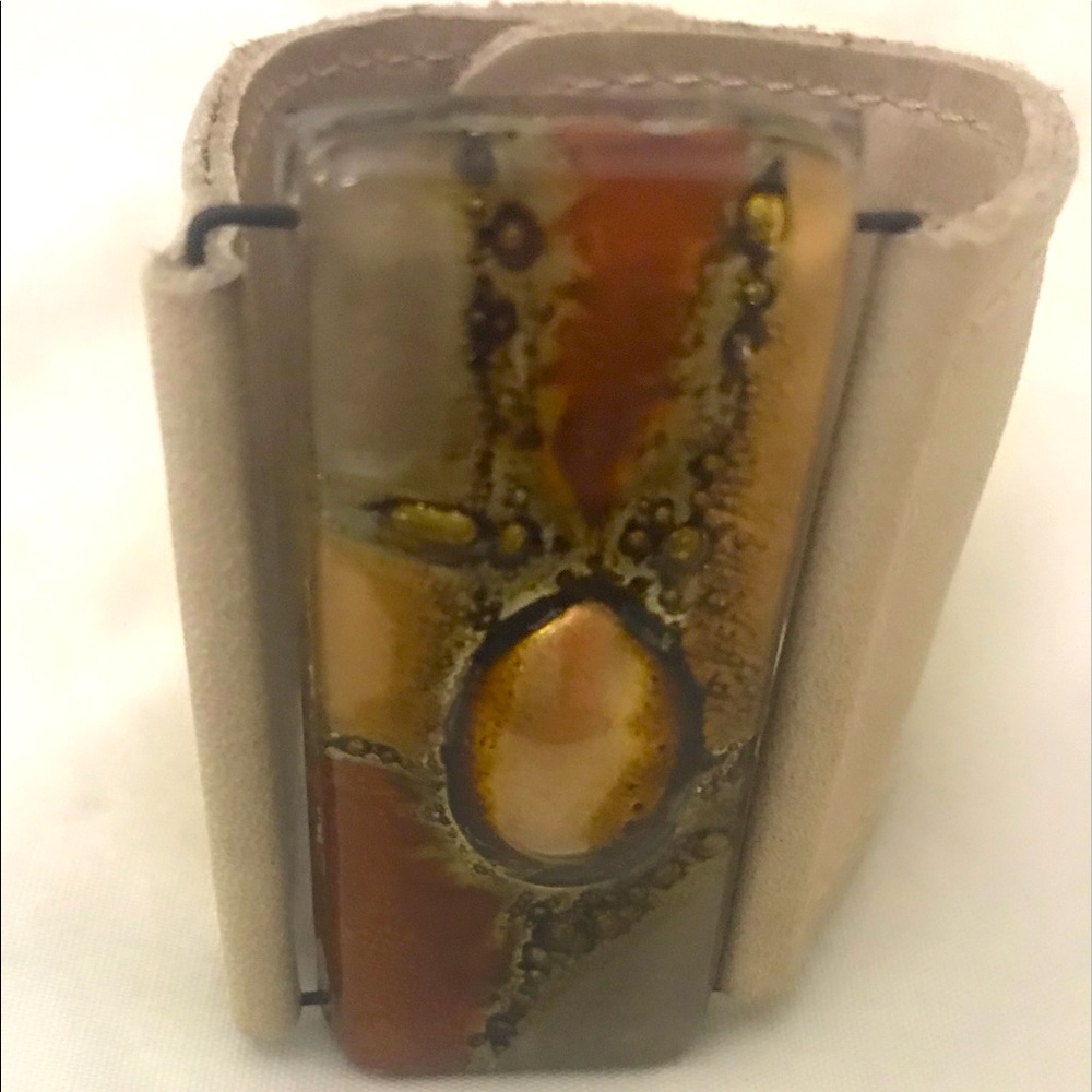 Wrist cuff with stained glass type of medallion. Adjustable 61/2” to 7” snaps.